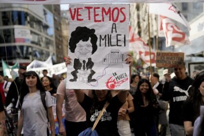 Manifestantes empunham cartazes contra o presidente argentino Javier Milei e seu veto à lei destinada ao financiamento das universidades públicas, durante protesto em Buenos Aires, na semana passada — Foto: Rodrigo Abd/AP